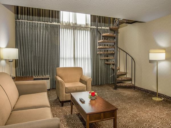 Living area of hotel suite with stairs