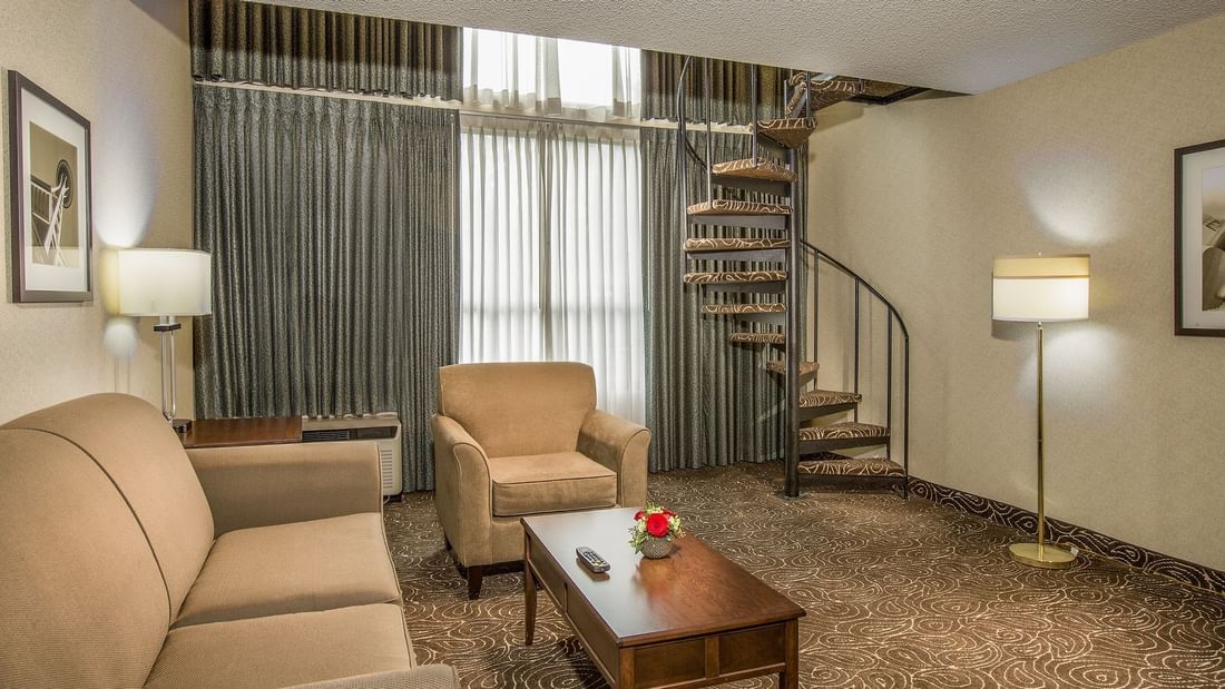 Living area of hotel suite with stairs