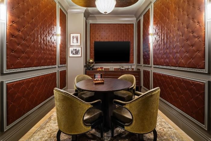 Elegant room with leather-paneled walls, round table, and four chairs at The 27 Wynwood