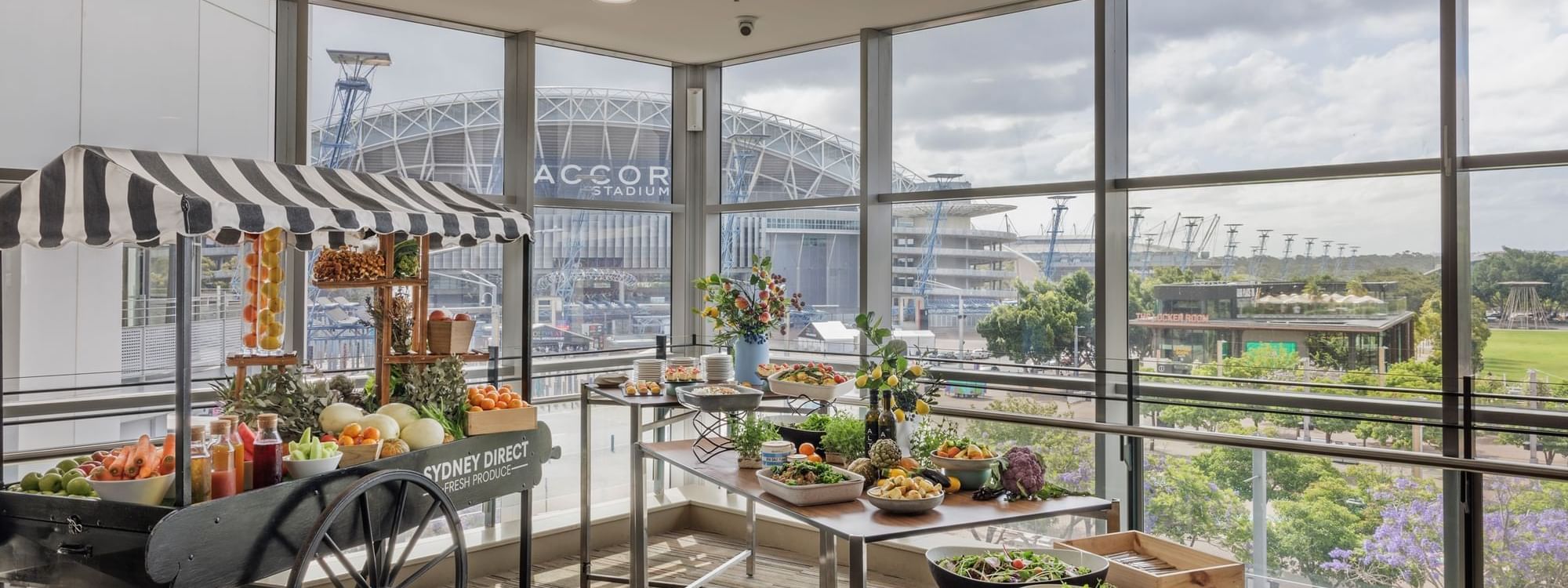 Pre-function area with a fruit cart and elegant tables of fresh food in Freshwater Ballroom at Novotel Sydney Olympic Park