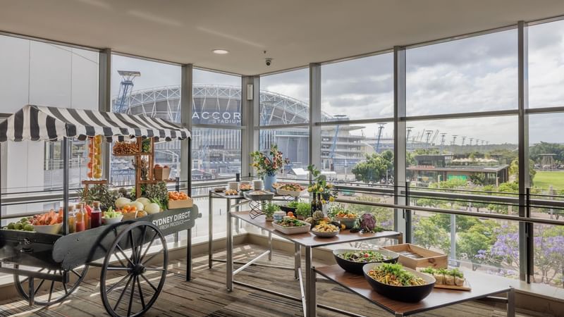 Pre-function area with a fruit cart and elegant tables of fresh food in Freshwater Ballroom at Novotel Sydney Olympic Park