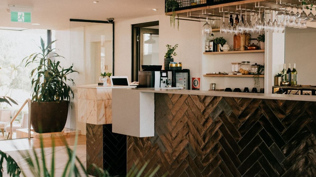 Stylish Mercure Charlestown hotel reception with modern decor and hanging lamps.
