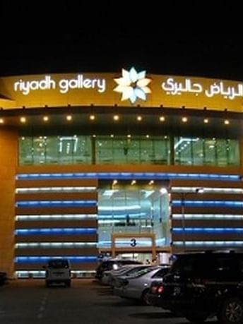 Exterior view of Shopping Malls Riyadh Gallery by a parking lot at night near Warwick Riyadh