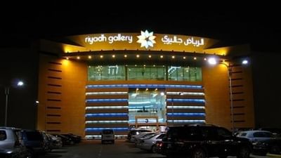 Exterior view of Shopping Malls Riyadh Gallery by a parking lot at night near Warwick Riyadh
