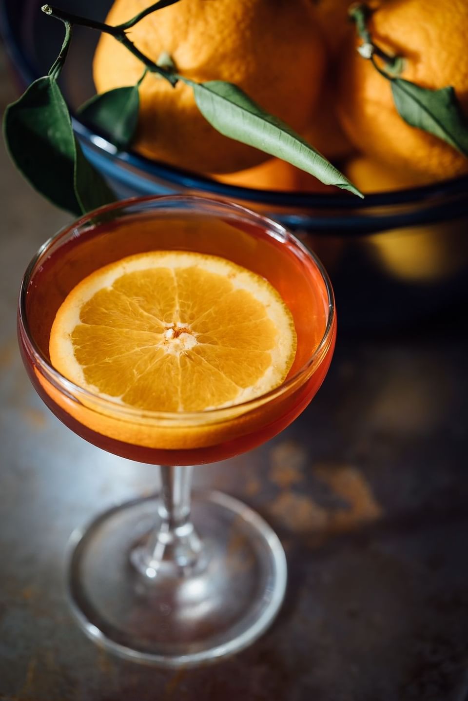 Close up on an orange cocktail made in Dbar at H On Smith Hotel