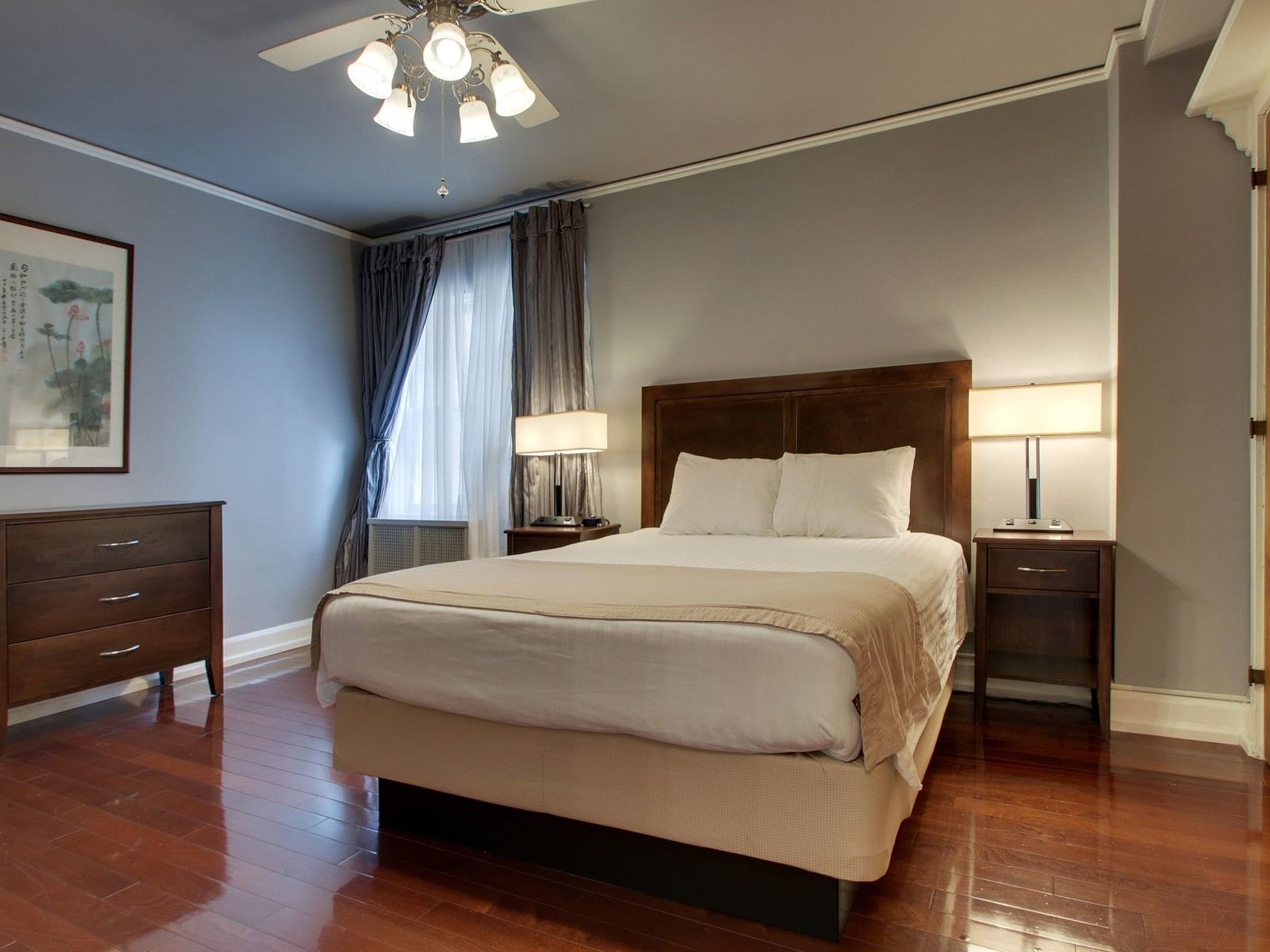 Dresser and nightstands by the bed in Two Bedroom Suite at Knickerbocker On The Lake, featuring accommodations in Milwaukee