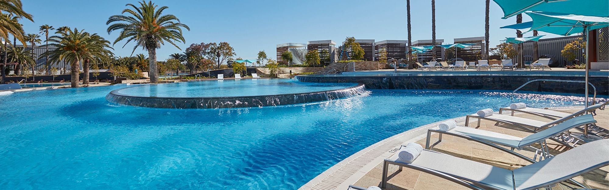 Swimming pool with sun loungers at Crown Towers Perth