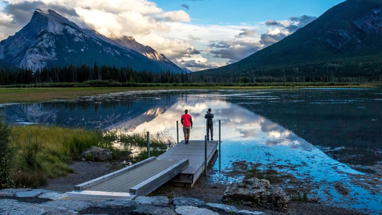 two people standing on a pier