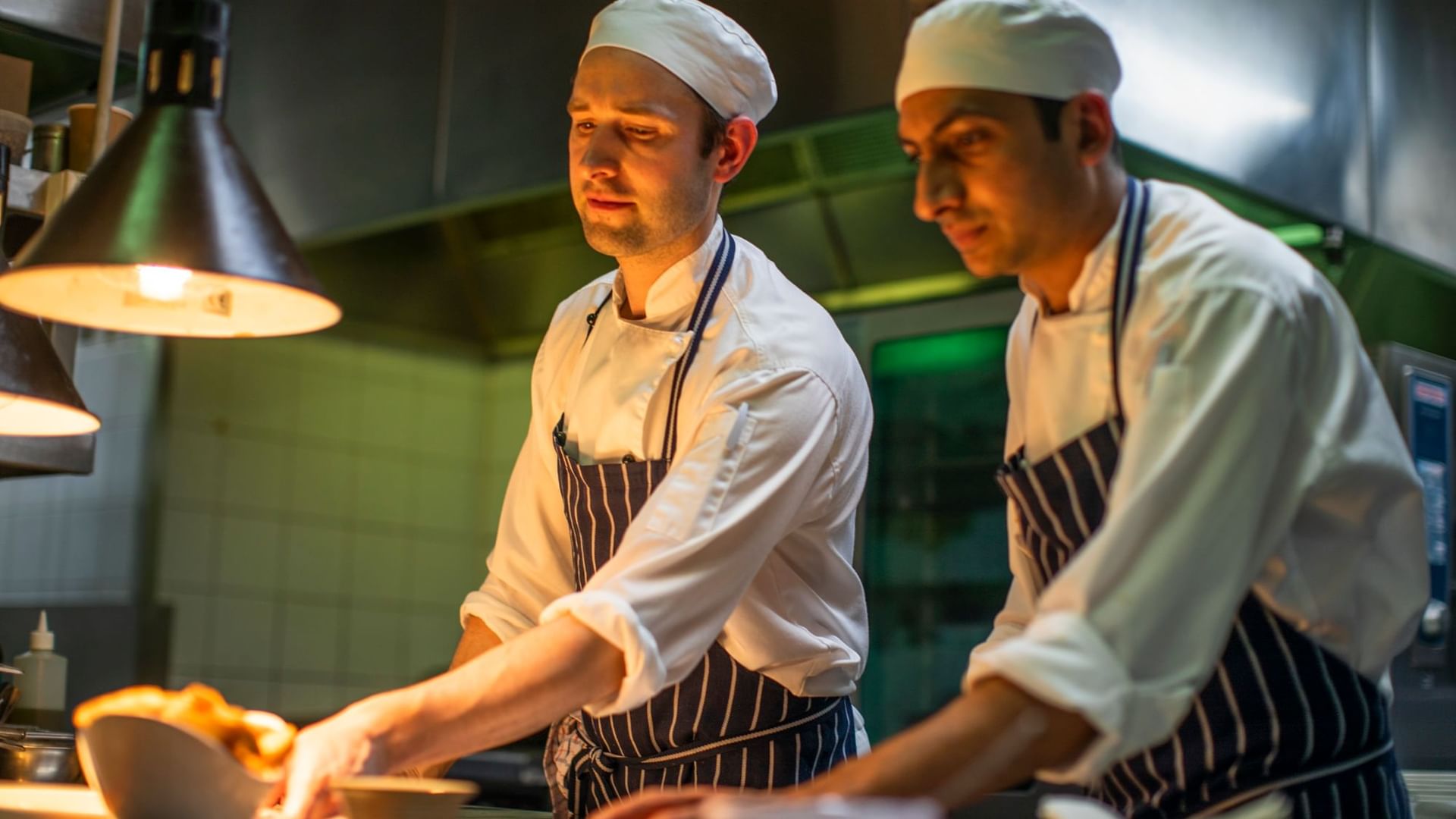 Close up on chefs preparing meal at Novotel Melbourne on Collin