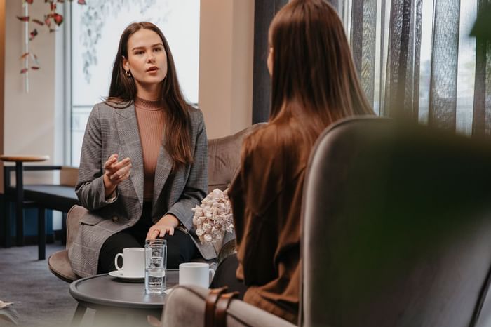 Two girls conducting a meeting in a room at Hotel Berlin Berlin