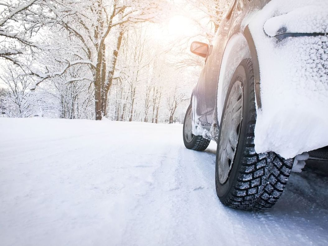 Closeup of car speeding during snow at Gouverneur Trois