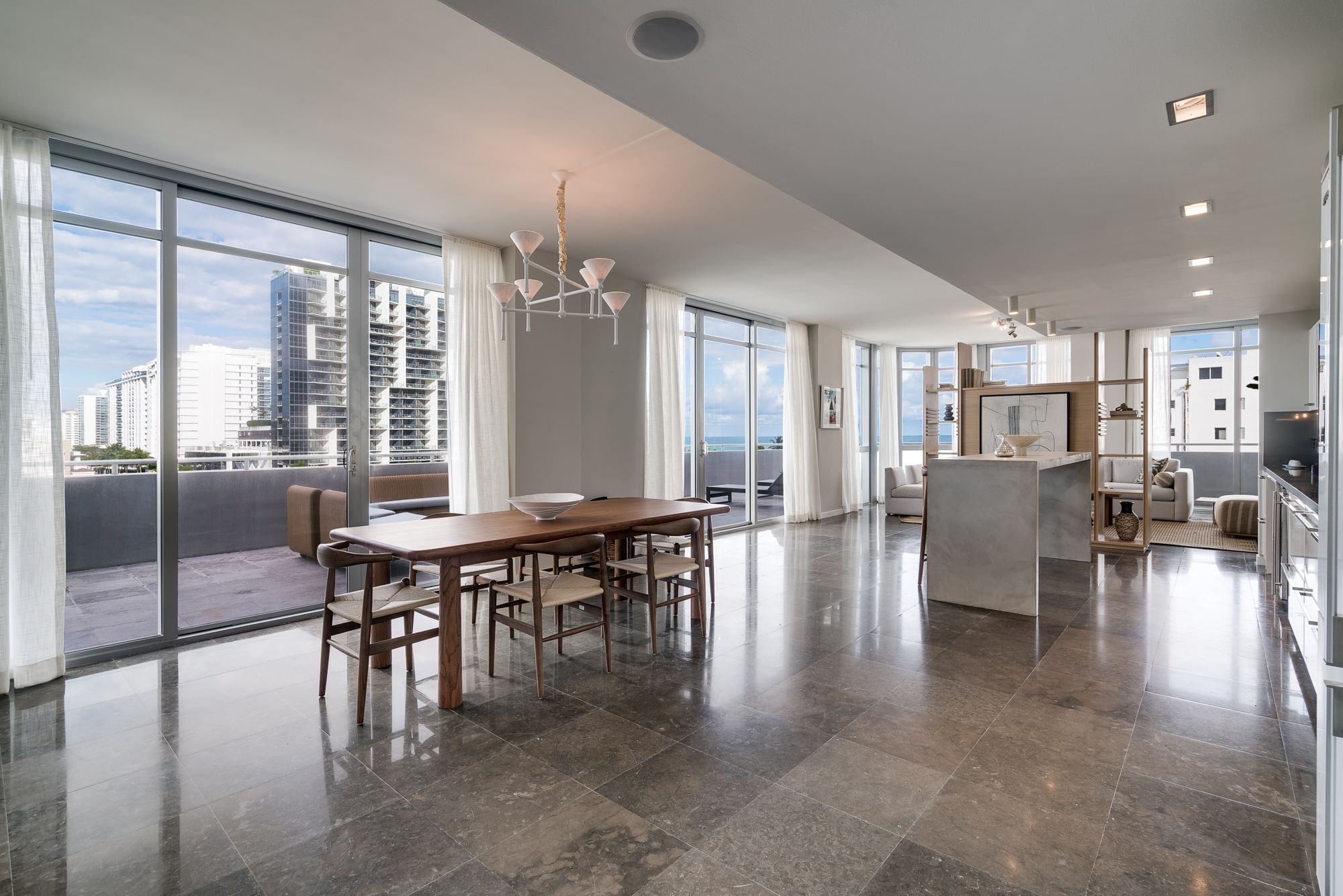 A modern, open-plan living and dining area with a city view.