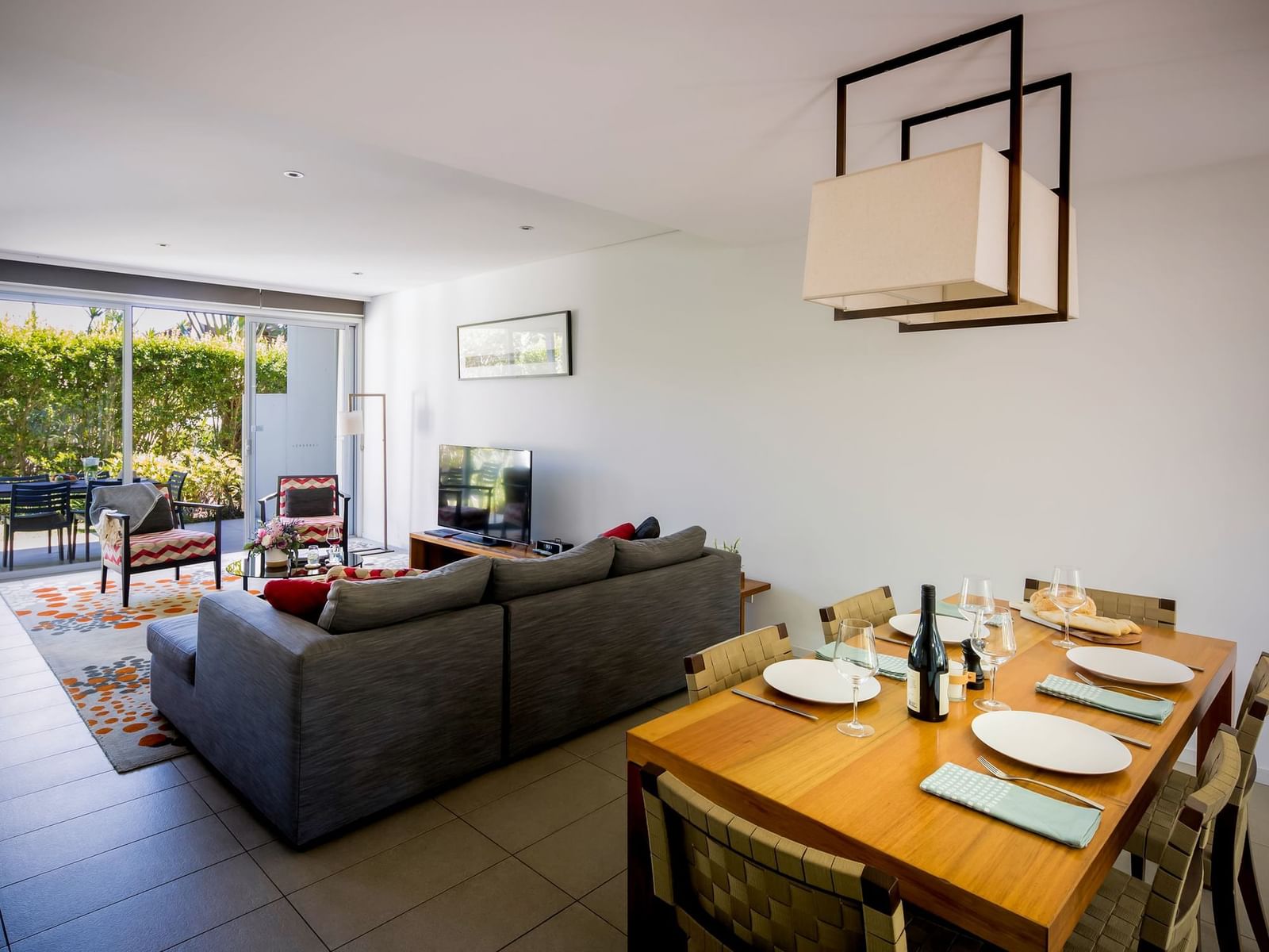 2 Bedroom Villa, living and dining area at Pullman Magenta Shores, featuring a large sofa and outdoor patio