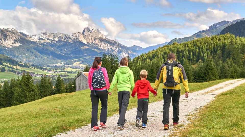 Posterior view of a family walking by a valley near Liebes Rot