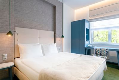 King bed & study table in the Executive suite at Metropol Hotel
