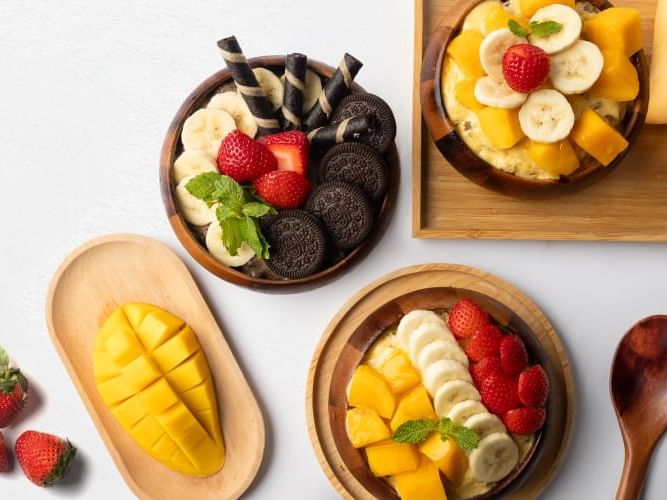 A wooden tray displays a diverse assortment of fresh fruits and vegetables.