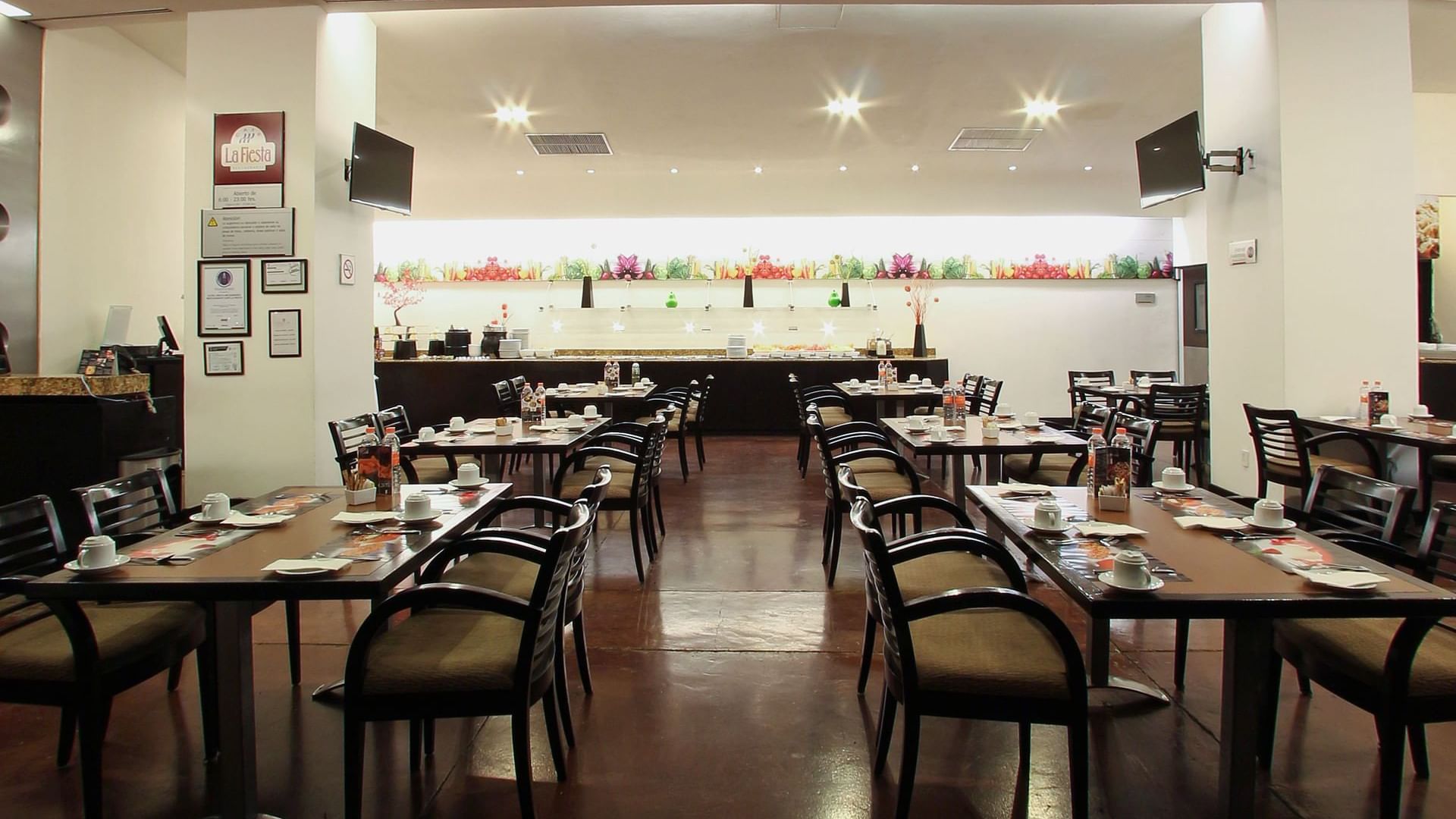 Dining tables set up in restaurant at Fiesta Inn Durango