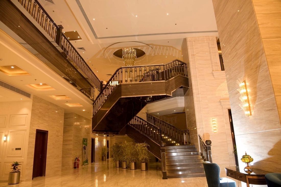 Lobby with a grand staircase & interior at Warwick Al Khobar