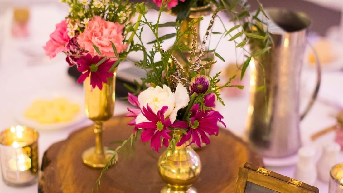 A beautifully arranged table centerpiece featuring vibrant flowers in Receptions at Mercure Hotel Townsville