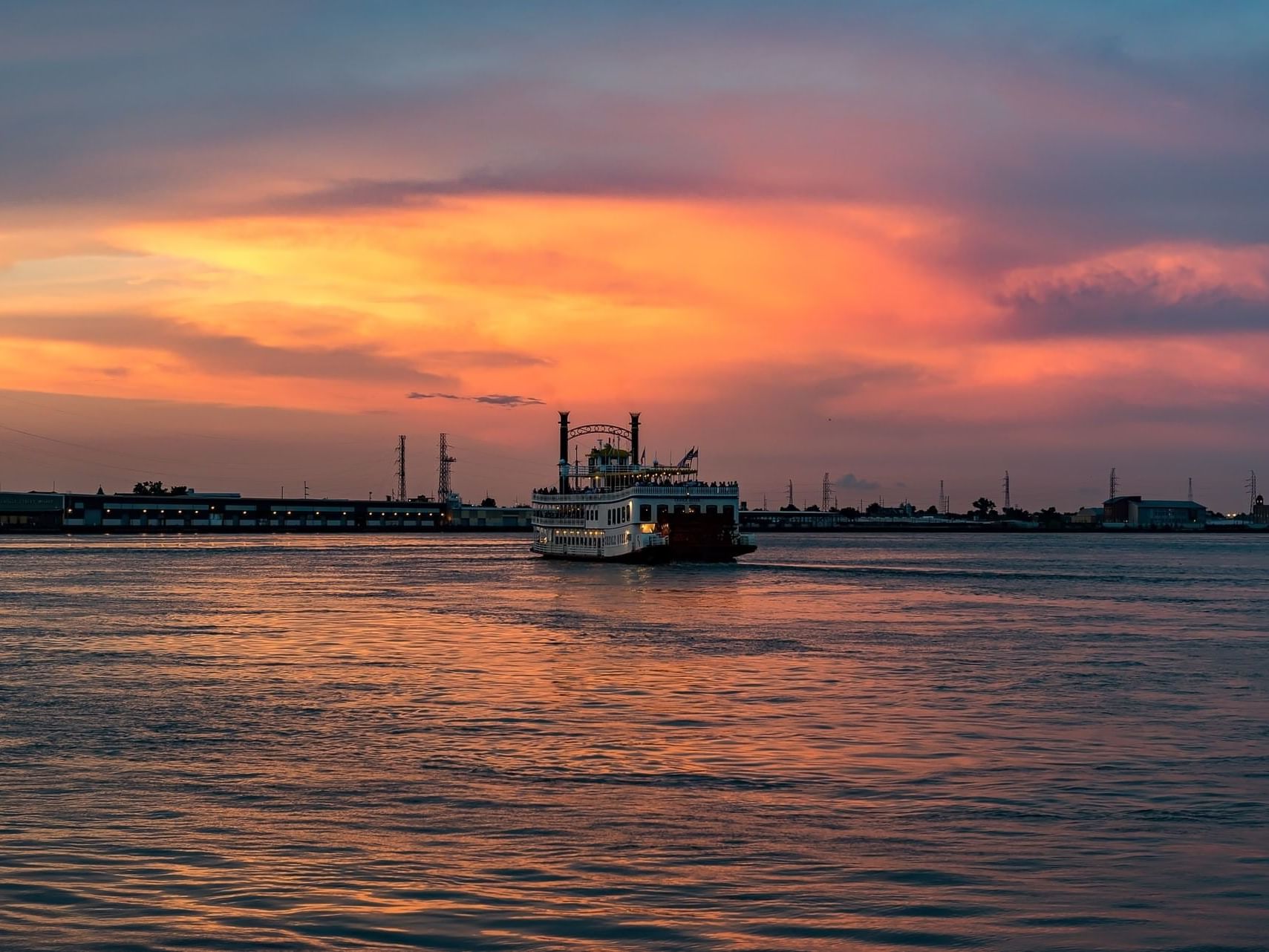 Distant view of Natchez Boat on the sea near La Galerie Hotel