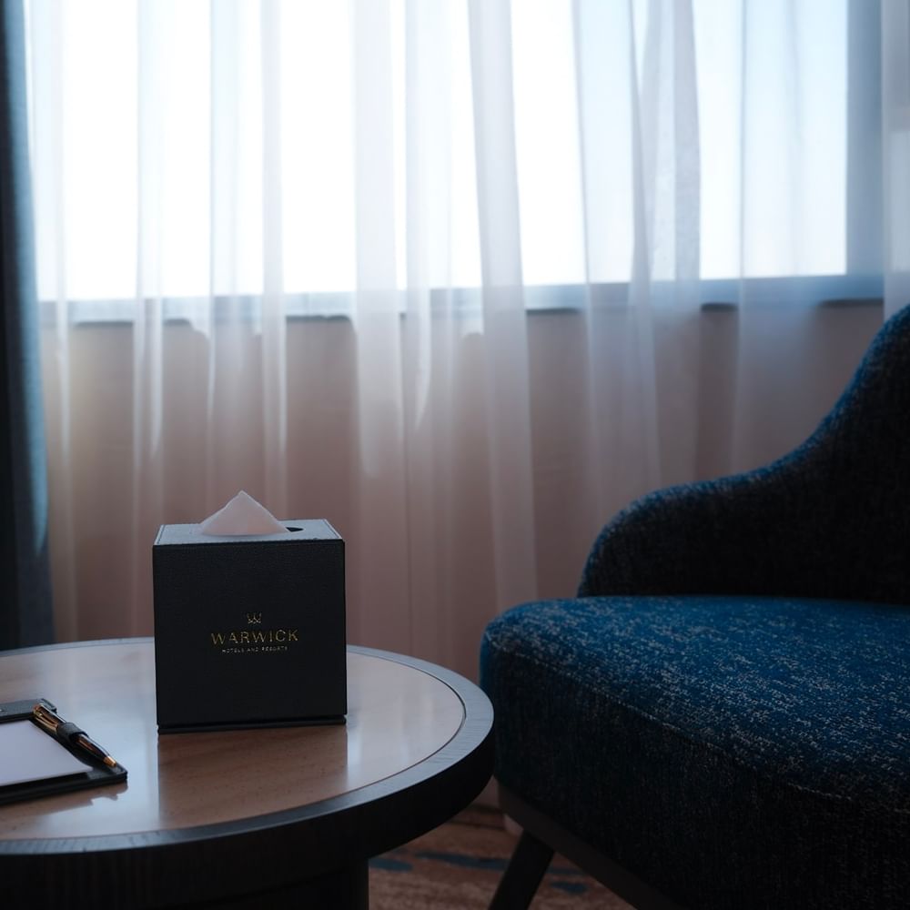 Warwick Hotel & Spa club room in Jeddah with a writing desk and a chair.