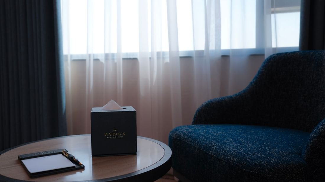 Warwick Hotel & Spa club room in Jeddah with a writing desk and a chair.