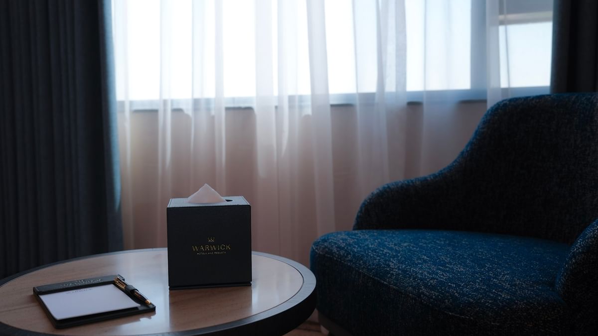 Warwick Hotel & Spa club room in Jeddah with a writing desk and a chair.