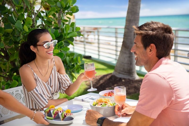 Couple dining by the beachside at The Diplomat Resort