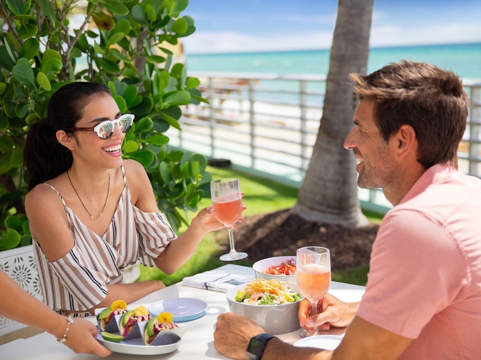 A couple dining at playa restaurant at Diplomat Beach Resort