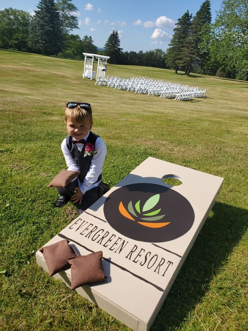 Page boy photographed with the Name board at Evergreen Resort