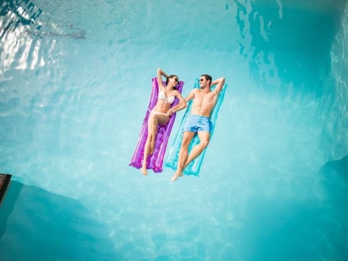Couple floating on the pool at  Safety Harbor & Resort