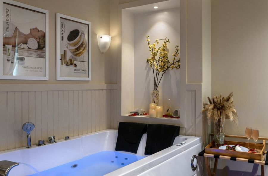 White tub by a snack tray under yellow flowers surrounding glow candles at Warwick Paradise Island Bahamas