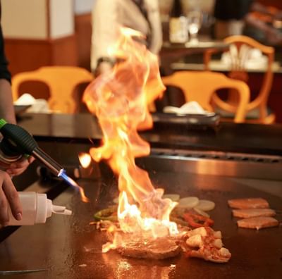 Chef making a meal by the dining tables at Hanoi Daewoo Hotel