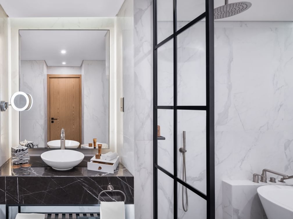 Bathroom vanity with a large mirror in Scene Room Coastal at Paramount Hotel Midtown