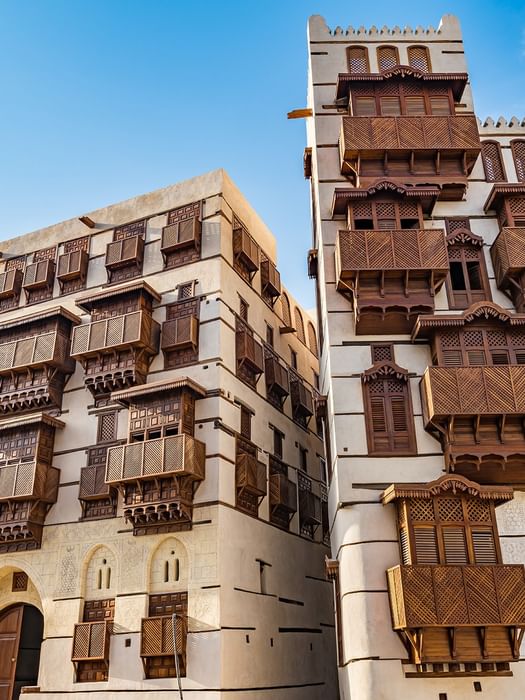 Traditional coral stone buildings in Al-Balad near Naviti by Warwick Jeddah, featuring historic spots to explore Jeddah