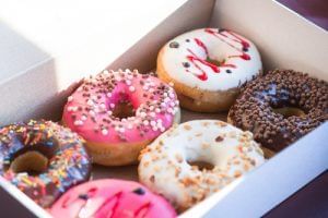 Colorful glazed doughnuts in a box at Rosen Inn Universal