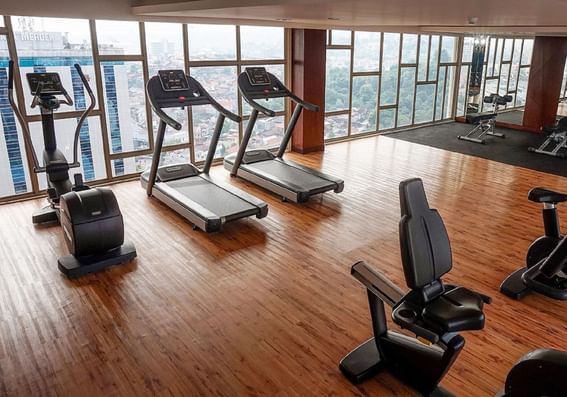 Exercise machines in the Gym with wooden floors at LK Pandanaran Hotel & Serviced Apartments