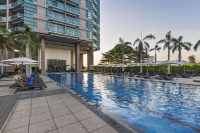 Sunbeds by the outdoor pool at Chatrium Hotel Riverside Bangkok
