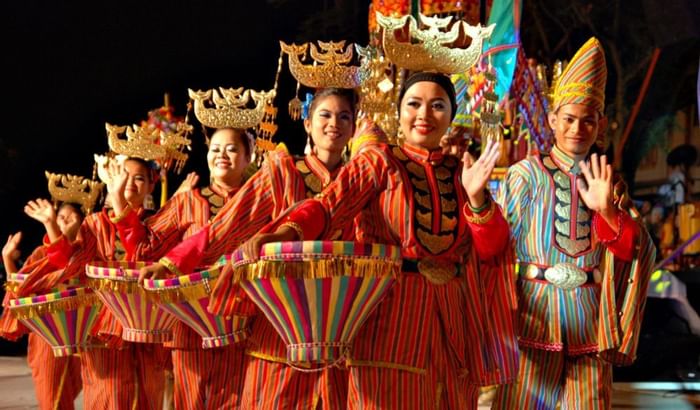 People in traditional costumes performing at a cultural event at Sunway Velocity Hotel