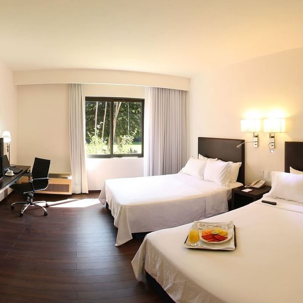 Twin beds in Superior Room with working desk at Fiesta Inn