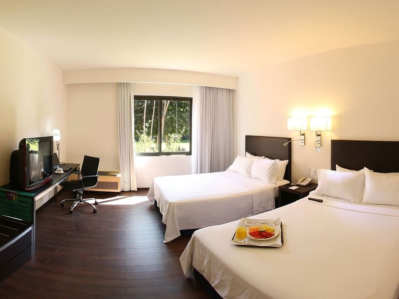 Twin beds in Superior Room with working desk at Fiesta Inn