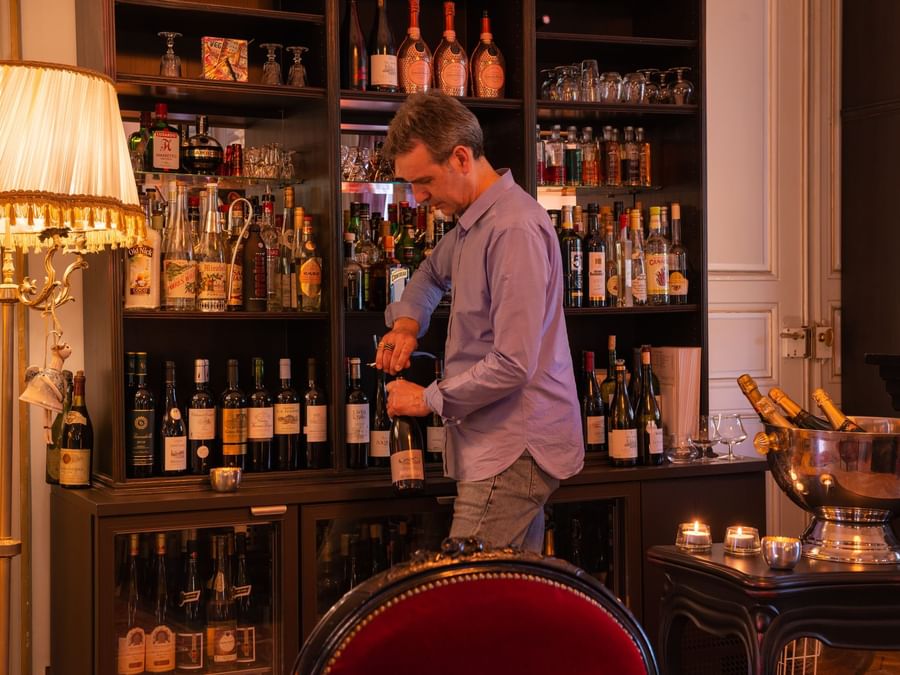 A man opening a bottle of wine Domaine de beaupre