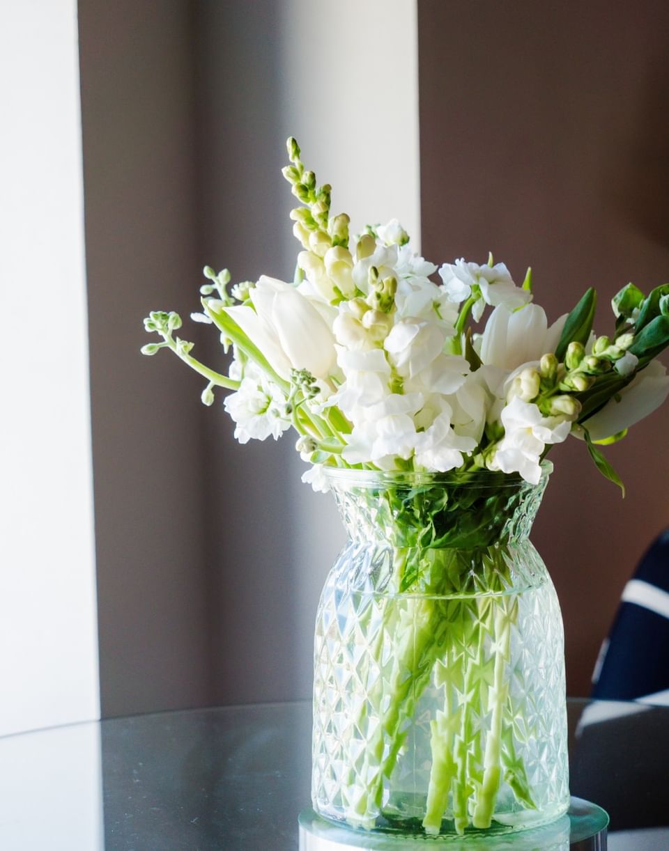Beautiful bouquet of white tulips and snapdragons in a textured clear glass vase in The Velvet Bean at The Markham Hotel