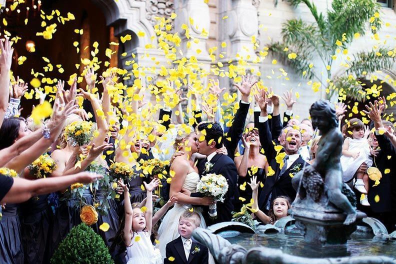 Wedding party throwing rose petals at Mission Inn Riverside