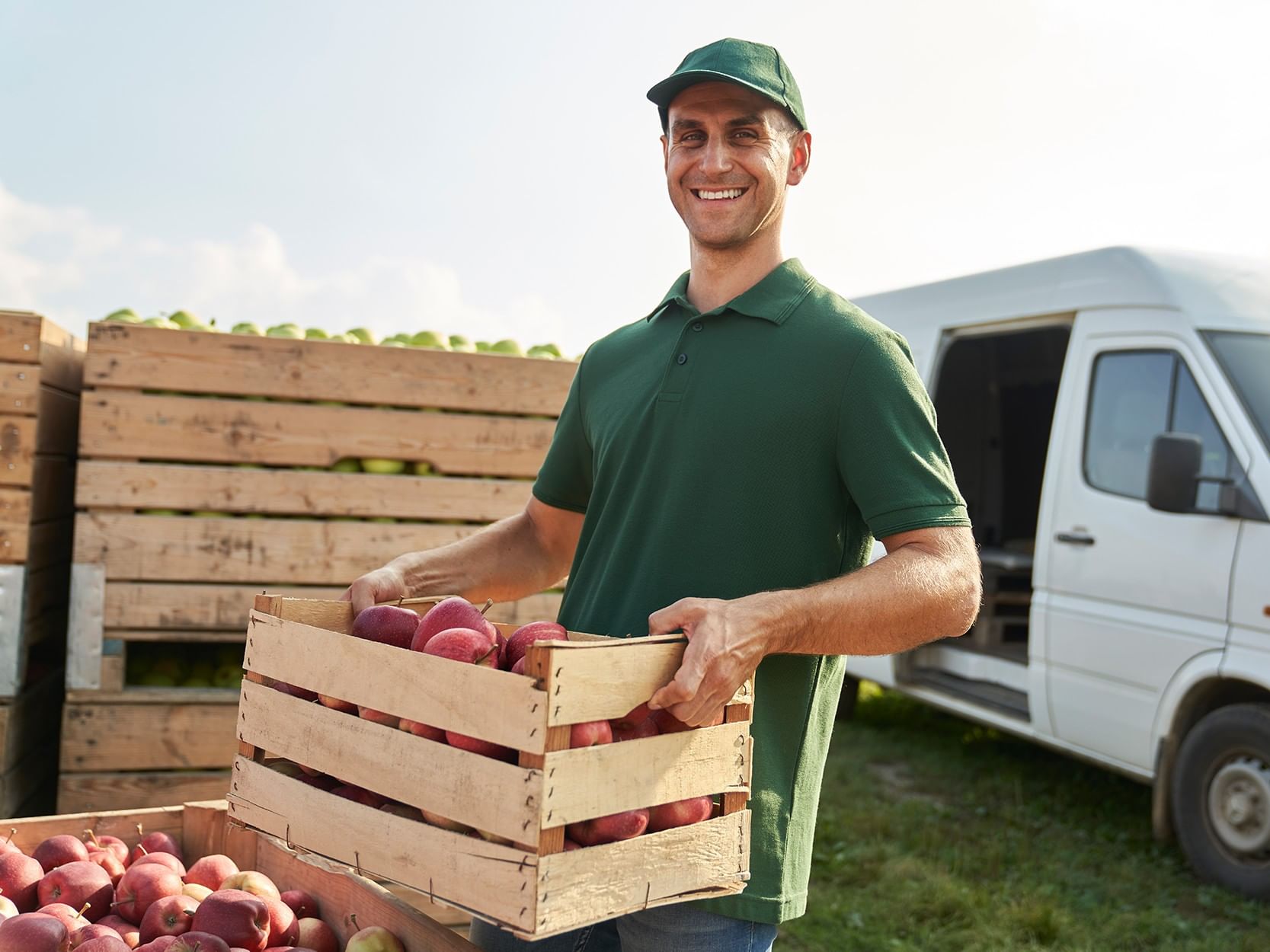 produce distrobution employee holding a basket of vegetables and fruits