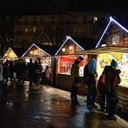 Night-time shopping at Christmas market near Originals Hotels