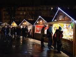 Night-time shopping at Christmas market near Originals Hotels