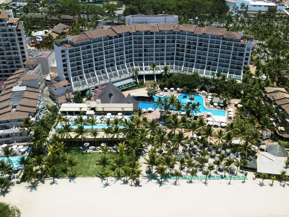Aerial view of hotel with pool and palm trees