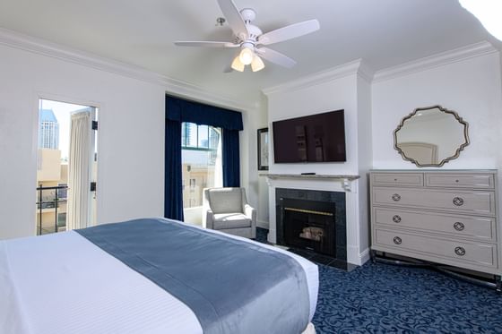 King bed with a TV and fireplace in a room at The Horton Grand