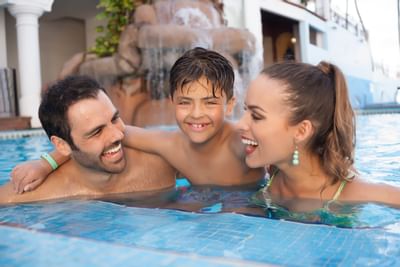 Loving family enjoying the pool at Playa Los Arcos